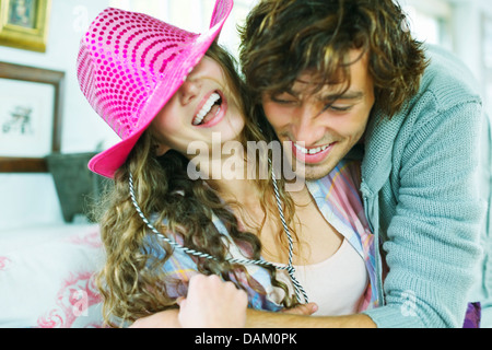 Smiling couple playing on sofa Stock Photo