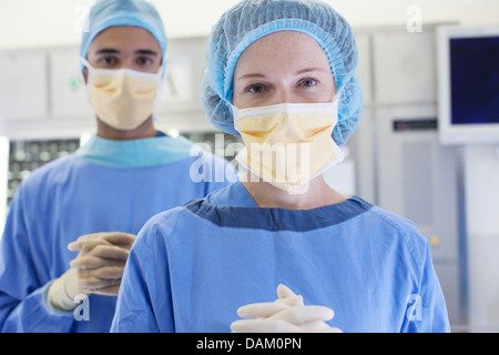 Surgeons standing in operating room Stock Photo