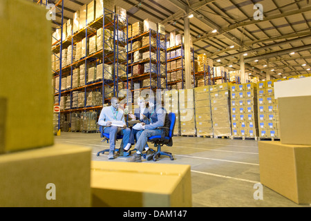 Business people talking in warehouse Stock Photo