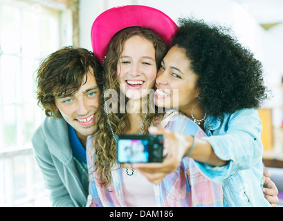 Friends taking picture together indoors Stock Photo