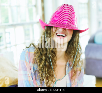 Woman wearing cowboy hat over her eyes Stock Photo
