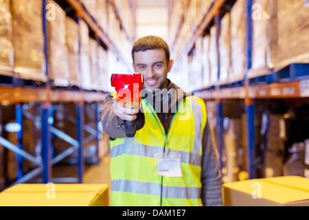 Worker holding scanner in warehouse Stock Photo