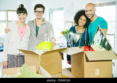 Friends unpacking boxes in new home Stock Photo