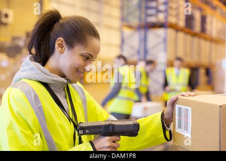 Worker scanning box in warehouse Stock Photo