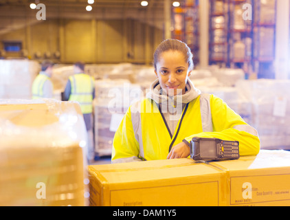 Worker smiling in warehouse Stock Photo