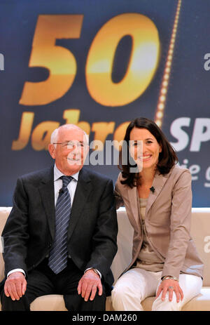 TV hosts Ernst Huberty (L) and Anne Will (R) pose at a photocall after the recording of a show to celebrate the 50th anniversary of First German Television (ARD) show 'Sportschau' in Huerth, Germany, 17 May 2011. For 50 years, 'Sportschau' reports about sports from all over the world. On 4 June 1961, it premiered on German television. Photo: Henning Kaiser Stock Photo