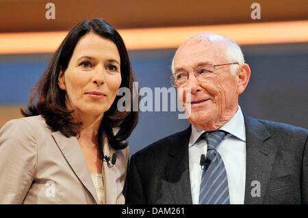 TV hosts Ernst Huberty (R) and Anne Will (L) pose at a photocall after the recording of a show to celebrate the 50th anniversary of First German Television (ARD) show 'Sportschau' in Huerth, Germany, 17 May 2011. For 50 years, 'Sportschau' reports about sports from all over the world. On 4 June 1961, it premiered on German television. Photo: Henning Kaiser Stock Photo