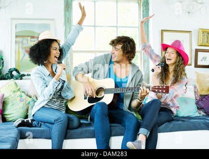 Friends singing and playing music together Stock Photo