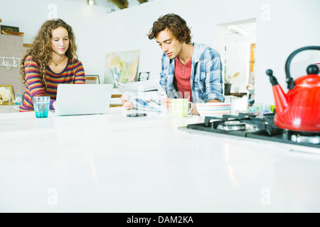 Couple relaxing together in kitchen Stock Photo