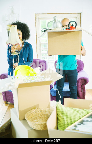 Couple unpacking boxes in new home Stock Photo
