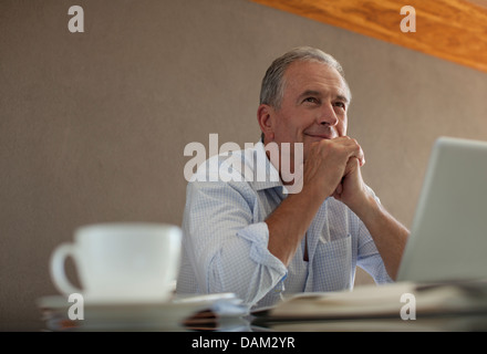 Businessman sitting at desk Stock Photo