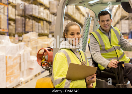 Workers smiling in warehouse Stock Photo