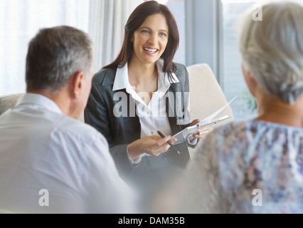 Financial advisor talking to clients in office Stock Photo