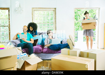 Friends relaxing in new home Stock Photo