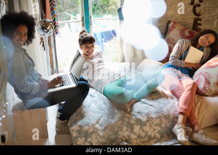 Women relaxing together in bedroom Stock Photo