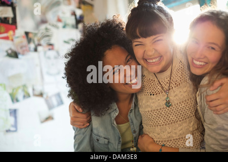 Women smiling together indoors Stock Photo