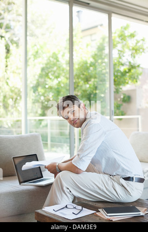 Businessman using laptop on sofa Stock Photo