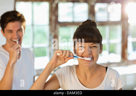 Couple brushing their teeth together Stock Photo