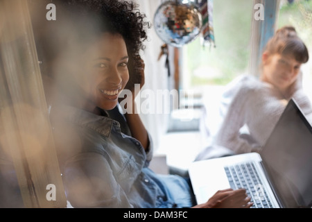 Woman using laptop in window Stock Photo