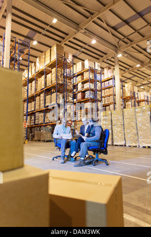 Business people talking in warehouse Stock Photo