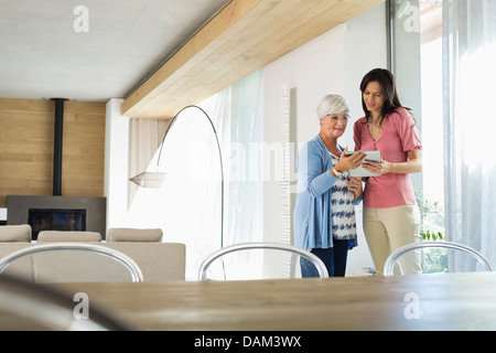 Women using tablet computer together Stock Photo