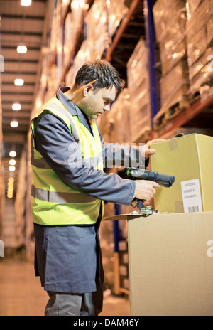 Worker scanning box in warehouse Stock Photo