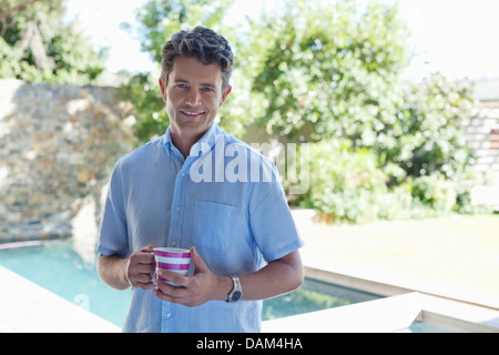 Man drinking cup of coffee outdoors Stock Photo