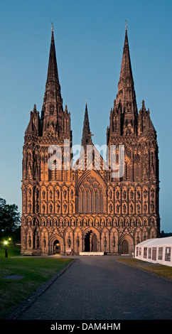 Flood lit west front of Lichfield Cathedral of St Chad with blue of late evening sky Stock Photo