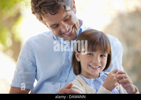 Father and daughter hugging outdoors Stock Photo