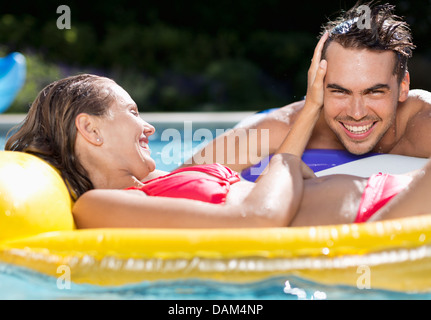 Couple relaxing in swimming pool Stock Photo