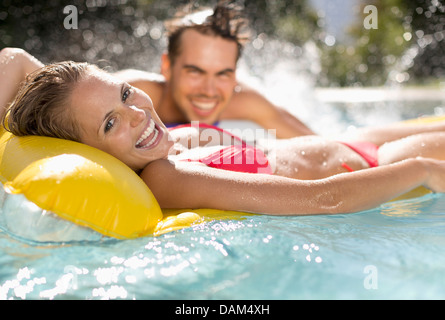 Couple relaxing in swimming pool Stock Photo