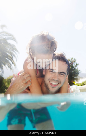 Couple playing in swimming pool Stock Photo