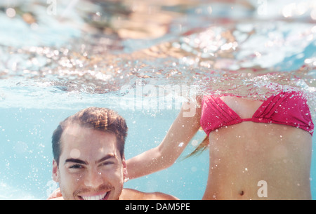 Female young adult in bikini listening to seashell Stock Photo - Alamy