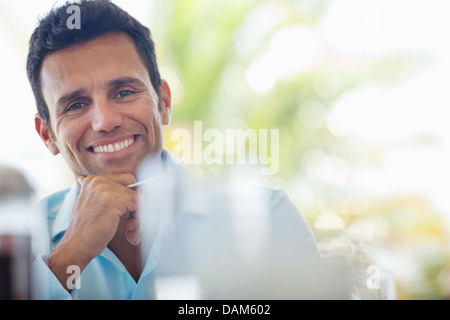 Businessman smiling at desk Stock Photo