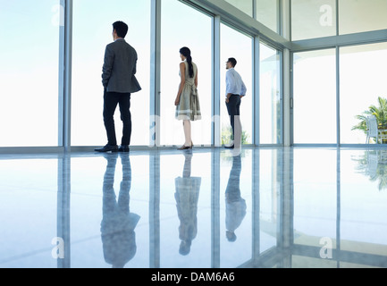 Reflections of business people in office floor Stock Photo