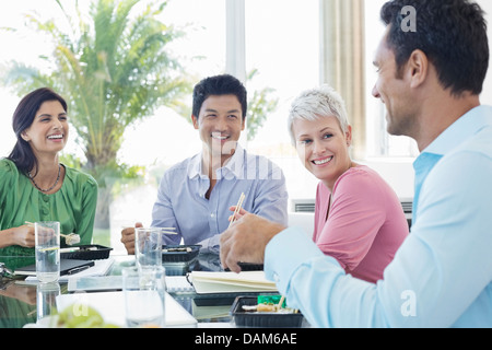 Business people smiling in lunch meeting Stock Photo