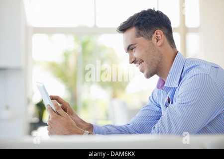 Businessman using tablet computer at desk Stock Photo