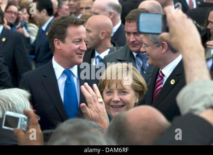 British Prime Minister David Cameron (L-R), German Federal Chancellor Angela Merkel, and Canadian Prime Minister Steven Harper speak to residents during the G8 Summit in Deauville, France, 26 May 2011. This year's G8 Summit is taking place in the French resort on the English Channel on 26 and 27 May 2011. Photo: PEER GRIMM Stock Photo