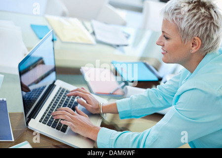 High angle view of businesswoman using laptop in office Stock Photo - Alamy