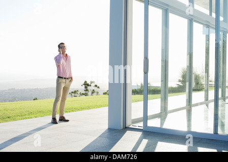 Businessman talking on cell phone outdoors Stock Photo