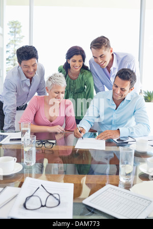 Business people signing contract in meeting Stock Photo