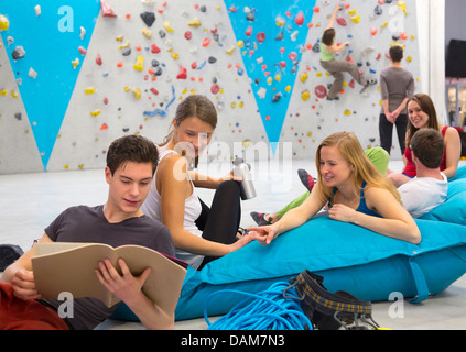Friends relaxing together, indoor climbing Stock Photo