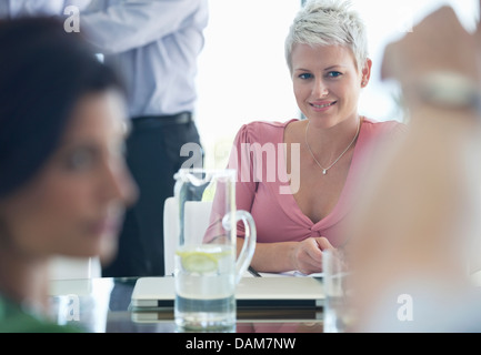 Businesswoman smiling in meeting Stock Photo
