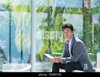 Businessman using tablet computer in office Stock Photo