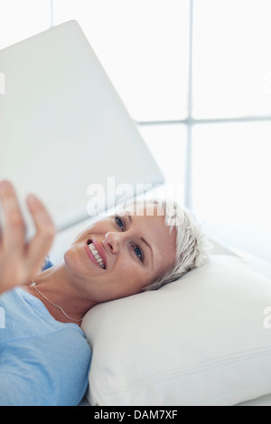 Business lady using tablet computer at desk Stock Photo - Alamy