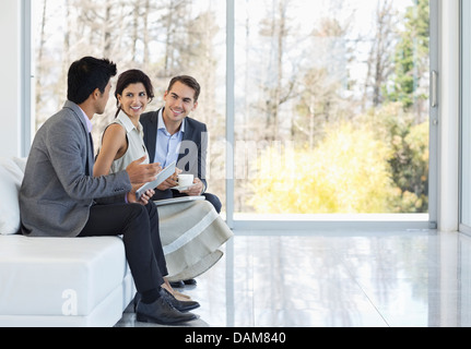 Business people talking on sofa in office