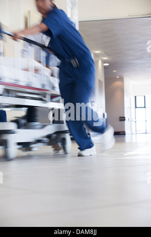 Hospital staff rushing patient to operating room Stock Photo