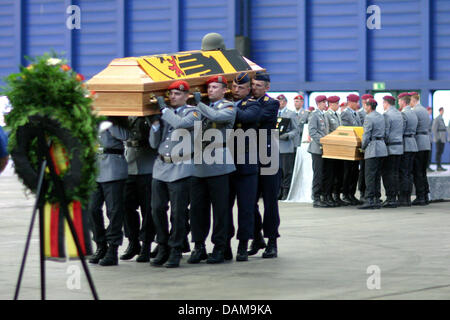 A Bundeswehr handout picture shows the coffins of the soldiers who were killed in Afghanistan on 25 may 2011 and 28 May 2011 arrive in Cologne, germany, 30 May 2011. The soldiers were transferred from Afghanistan via air transport and welcomed with military honours. Photo: Dana Kazda/Bundeswehr / HANDOUT / EDITORIAL USE ONLY Stock Photo