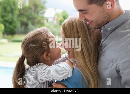 Mother and daughter touching noses outdoors Stock Photo
