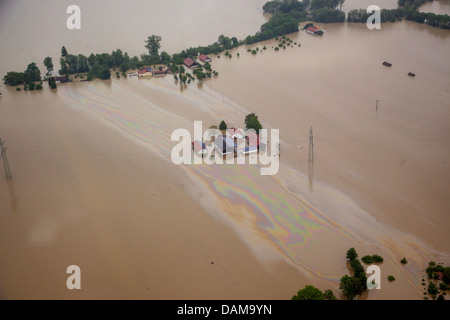 farmhouses and large oil layer on river Inn during the flood in June 2013, Germany, Bavaria Stock Photo